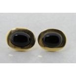 Onyx stud earrings, oval cabochon cut onyx, rubover set in 18ct yellow gold