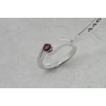 Single stone ruby twist ring, central round cut ruby, mounted in 18ct white gold, ring size J