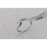 Single stone diamond twist ring, central round brilliant cut diamond, with round brilliant cut