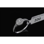 Diamond cluster ring, central round brilliant cut diamond, surrounded by a halo of diamonds and