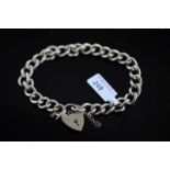 9ct yellow gold curb bracelet, with heart padlock and safety chain, gross weight approximately 29