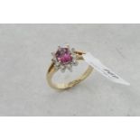Pink tourmaline and diamond ring, oval cut pink tourmaline surrounded by ten round brilliant cut
