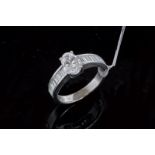 Single stone diamond ring with diamond set shoulders, central oval cut diamond weighing an estimated