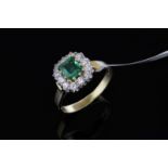 Emerald and diamond cluster ring, square cut emerald weighing an estimated 0.60ct, surrounded by