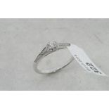 Diamond cluster ring, central round brilliant cut diamond, surrounded by a halo of diamonds and