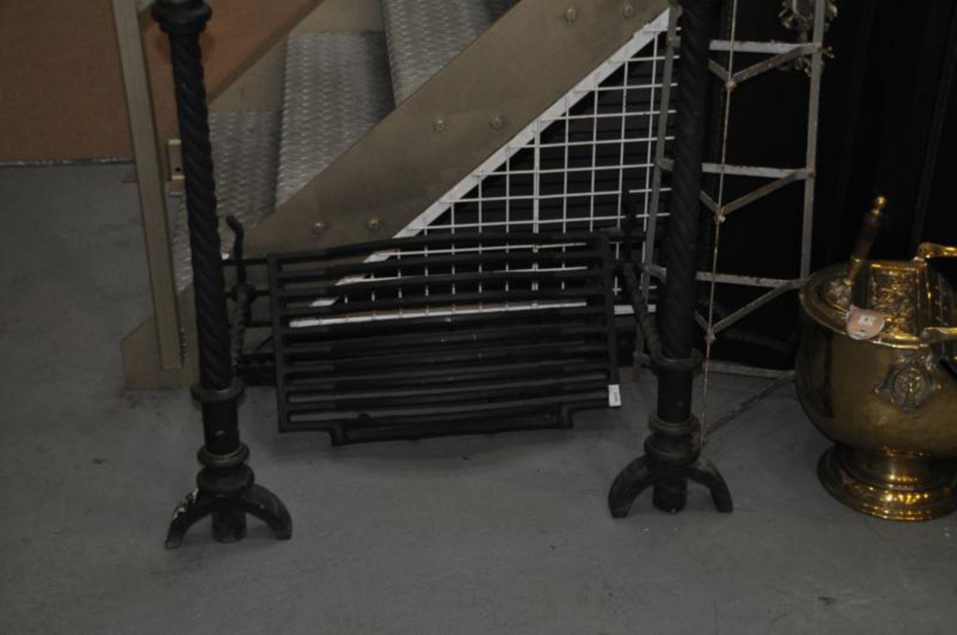 Pair of tall rope twist cast iron fire dogs with grate to match