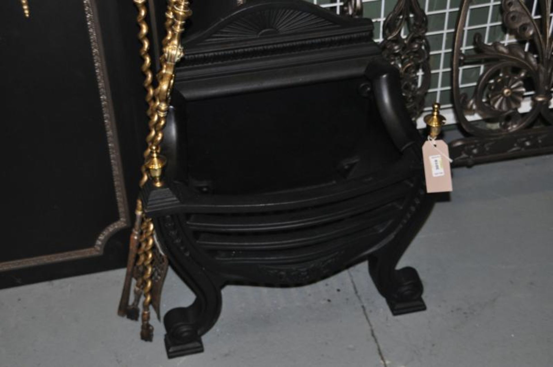 Regency design cast iron fire basket with brass finials