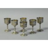 *Judaica - A set of six George V silver kiddush cups on stem, Birmingham 1910, gross weight