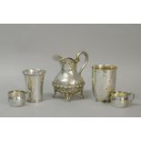 *A 19th century German white metal milk jug, two cup holders, and two 800 standard continental