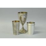 *A German white metal goblet and two cups, all marked 800 standard, gross weight approximately 237