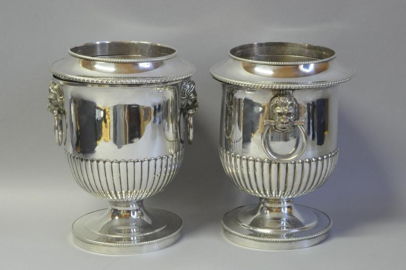 A pair of silver plated urn shaped wine coolers with lion mask handles, approximately 25cm high