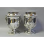 A pair of silver plated urn shaped wine coolers with lion mask handles, approximately 25cm high