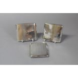 Three silver cigarette cases, gross weight approximately 395 grams