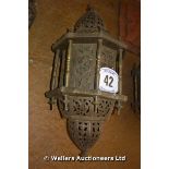 AN ISLAMIC BRASS HANGING PORCH LIGHT WIRED FOR ELECTRICITY WITH PROFUSE PIERCED DECORATION, 600