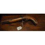 An early 19th century percussion pistol with walnut fullstock, engraved lock plate and flat sided