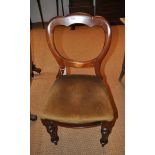 A set of eight Victorian balloon back dining chairs with bow fronted drop in seats, on turned