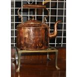 A copper teapot on a brass trivet