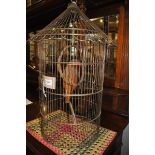A Parrot cage with ornamental wicker parrot
