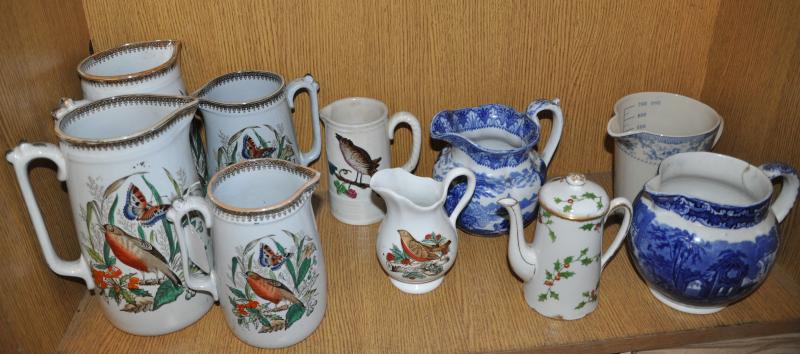 A collection of ten assorted jugs including a set of four Edwardian graduated jugs printed with