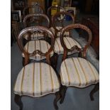 A set of four Victorian inlaid mahogany dining chairs with recently upholstered cushioned seats