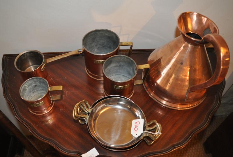 A copper ale jug, a small copper saucepan, three copper grain measures, four copper bowls and two
