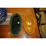 A pair of French faience green glazed serving dishes together with four similar ochre glazed serving