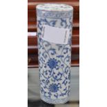 A Chinese blue and white porcelain scroll weight of oval section, foliate scroll design, four