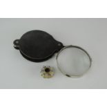 A Victorian magnifying pendant spy glass and a large horn cased magnifying glass (2)