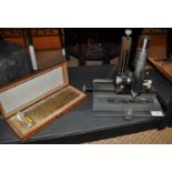 A precision microscope and a box of slides