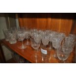 A set of six cut glass high tumblers with star bases; eleven matching sherry glasses; five