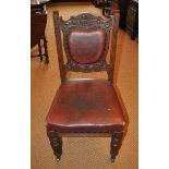 A set of eight Victorian mahogany carved dining chairs with red leather upholstery