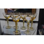 Six Stuart wine glasses, amber colouration with air twist stems, 16cm high