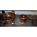 A Victorian copper preserving pan, various saucepan lids and other copper bowls