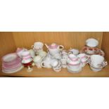 Three shelves containing a large quantity of Victorian and later porcelain part tea and coffee sets