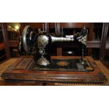 *A restored scythe and a Jones nicely decorated sewing machine (Lot subject to VAT)