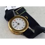 9ct gold cased wristwatch, unmarked white circular dial with Arabic numerals on a black ribbon