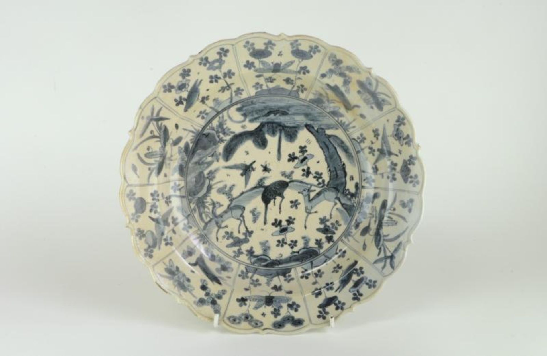An Oriental Kraak style plate, probably provincial Chinese, painted in the centre with deer, the