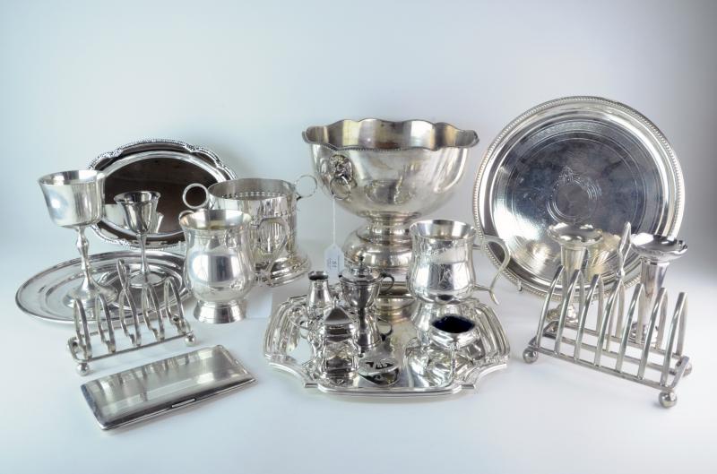 A bowl with lion mask handles, a plated wine bottle stand, a plated tray with beaded borders,