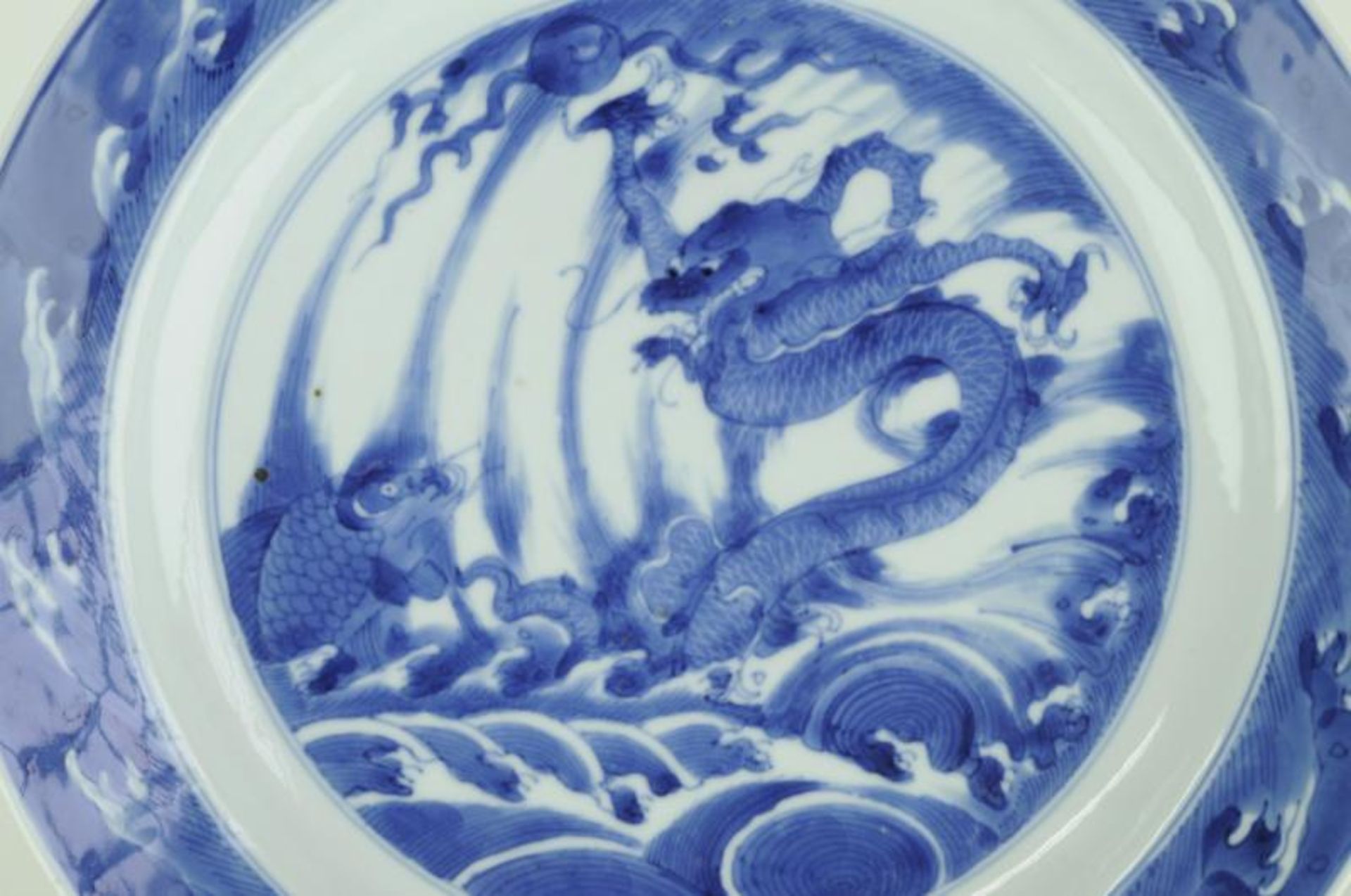 A Chinese Kangxi marriage plate painted with a dragon and a carp leaping from the waves, within a - Image 2 of 4