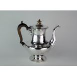 A William IV baluster shaped silver coffee pot engraved with a coat of arms, London 1830