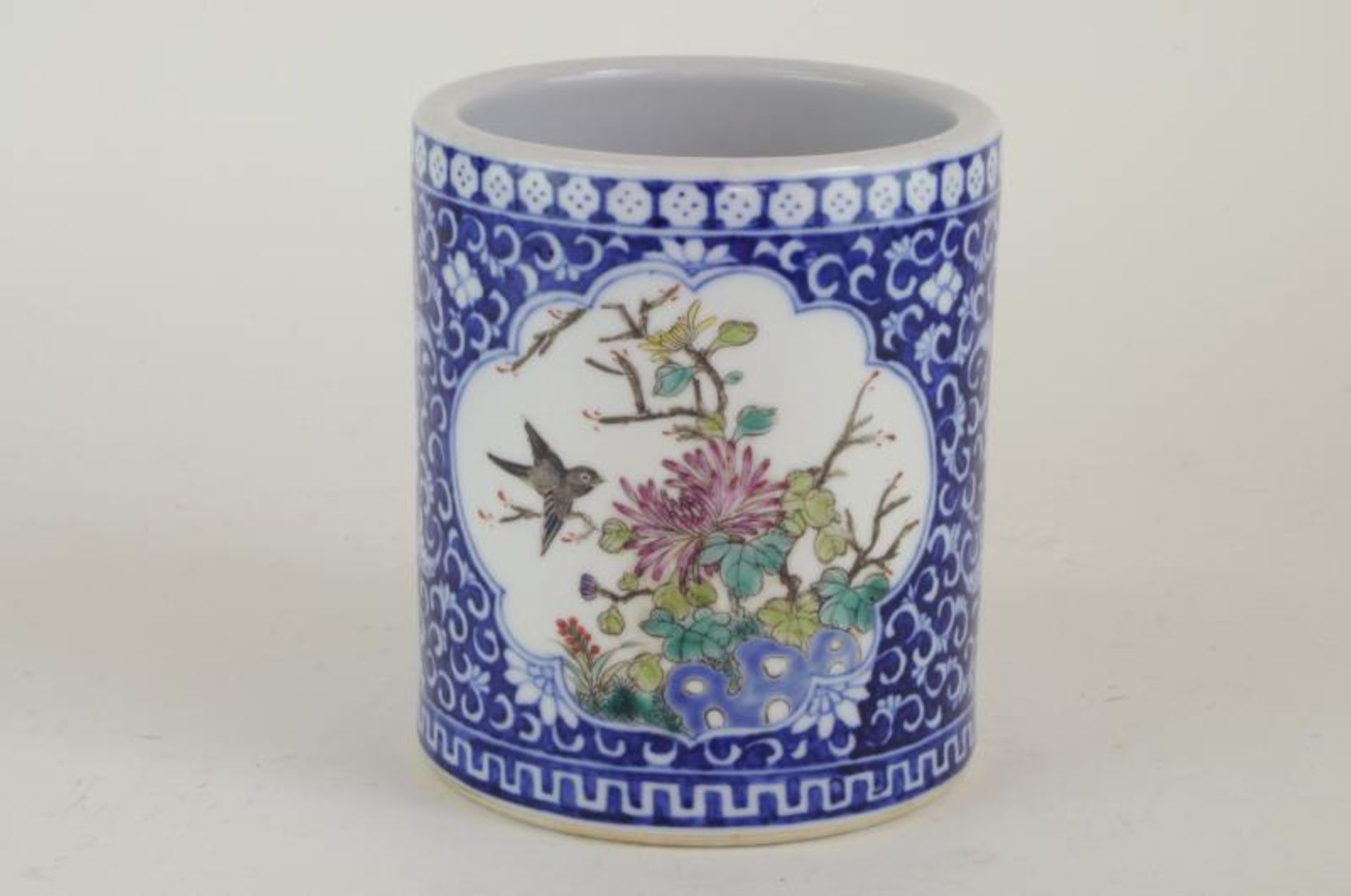 A Chinese Xianfeng famille rose brush pot, with polychrome cartouches on a blue ground, six