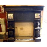 *A LATE VICTORIAN FIRE SURROUND MADE FROM 17TH CENTURY OAK PANELLING WITH TWO PANELS OF DELFT TILES,