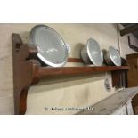*A BROWN PAINTED SHELF WITH BACK RAIL