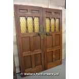 *A PAIR OF OAK PART GLAZED DOORS WITH UNUSUAL BRASS DOOR HANDLES AND PLATES, EACH 770 X 2030