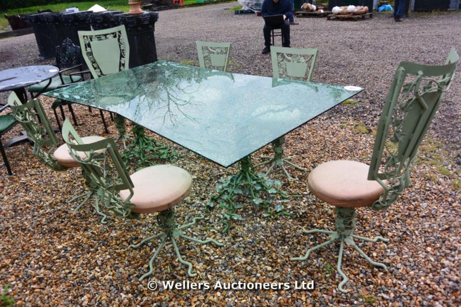 CONSERVATORY/PATIO SUITE WITH SHAPED GLASS TOPPED PATIO TABLE ON A FORGE MADE ROOT DESIGN TWIN