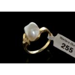Baroque pearl and diamond dress ring, three Swiss cut diamonds, mounted in yellow metal stamped