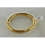 9ct yellow gold oval hinged bangle, with figure of eight safety catch, gross weight approximately