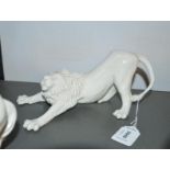 A Nymphenburg porcelain figure of a crouching lion, impressed 661, 22cm long