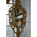 A pair of gilt framed shield shaped mirrors.
