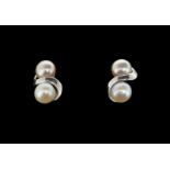 Pearl ear studs, each earring set with a 5.6mm pink pearl and a 5.7mm white pearl, set in a twist